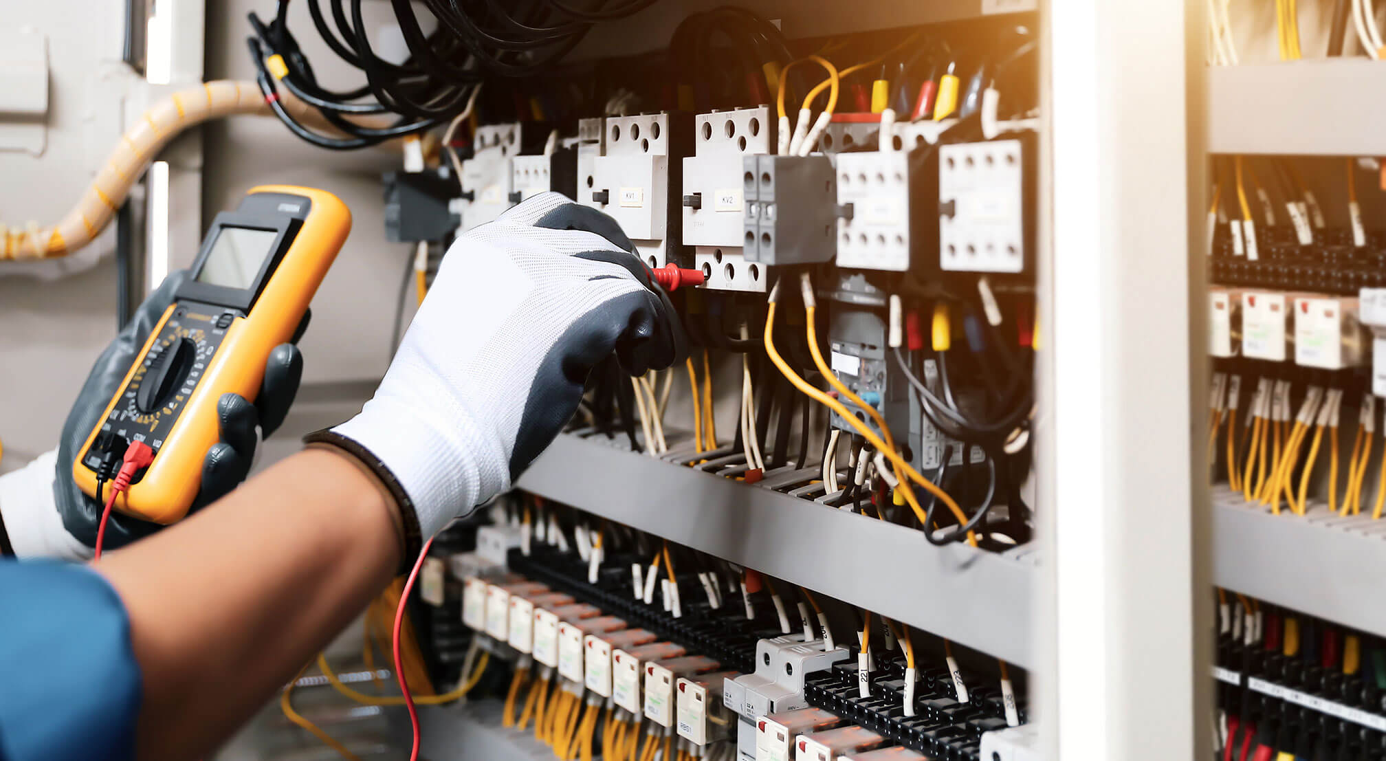 Hands working on an electrical unit
