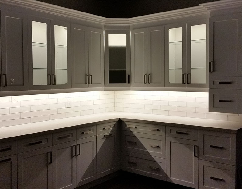 Kitchen cabinet lighting setup in a dark room